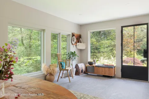 a bedroom with a bed and glass window