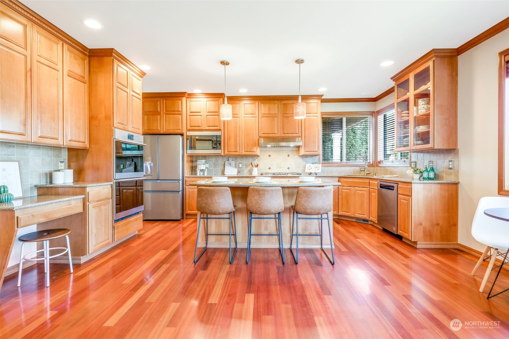 4013 214th Street Southeast Bothell, WA 98021 - Photo 11 of 40 a kitchen with stainless steel appliances wooden floors and wooden cabinets