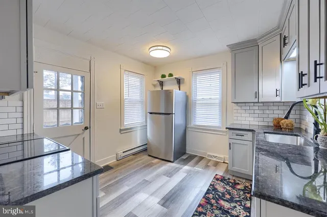 a kitchen with a refrigerator and a sink