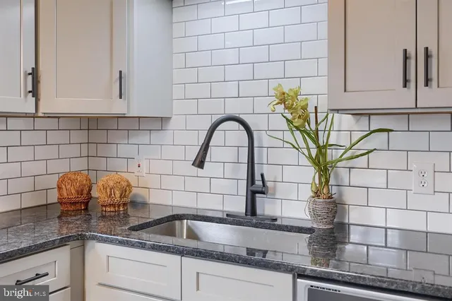 a kitchen with a sink and cabinets