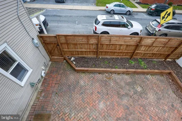 a view of a house with a wooden fence