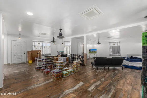 a living room with furniture and a wooden floor