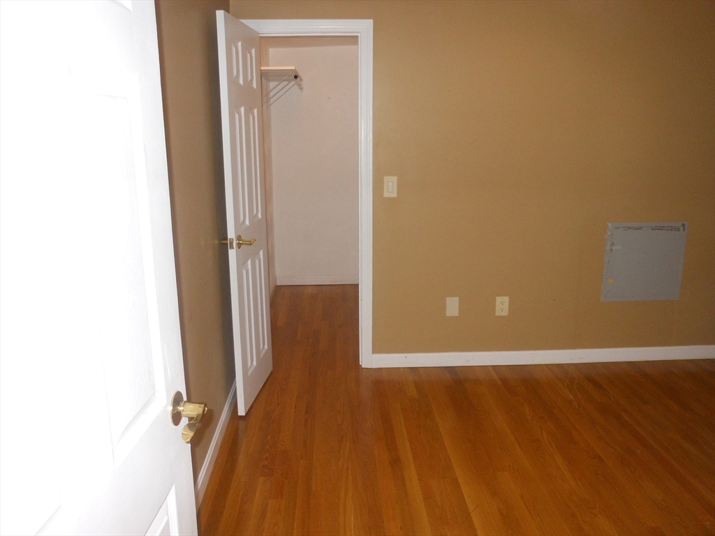 21 Cook, Unit 1 Chelsea, MA 02150 - Photo 29 of 32 a view of a room with wooden floor and a hallway