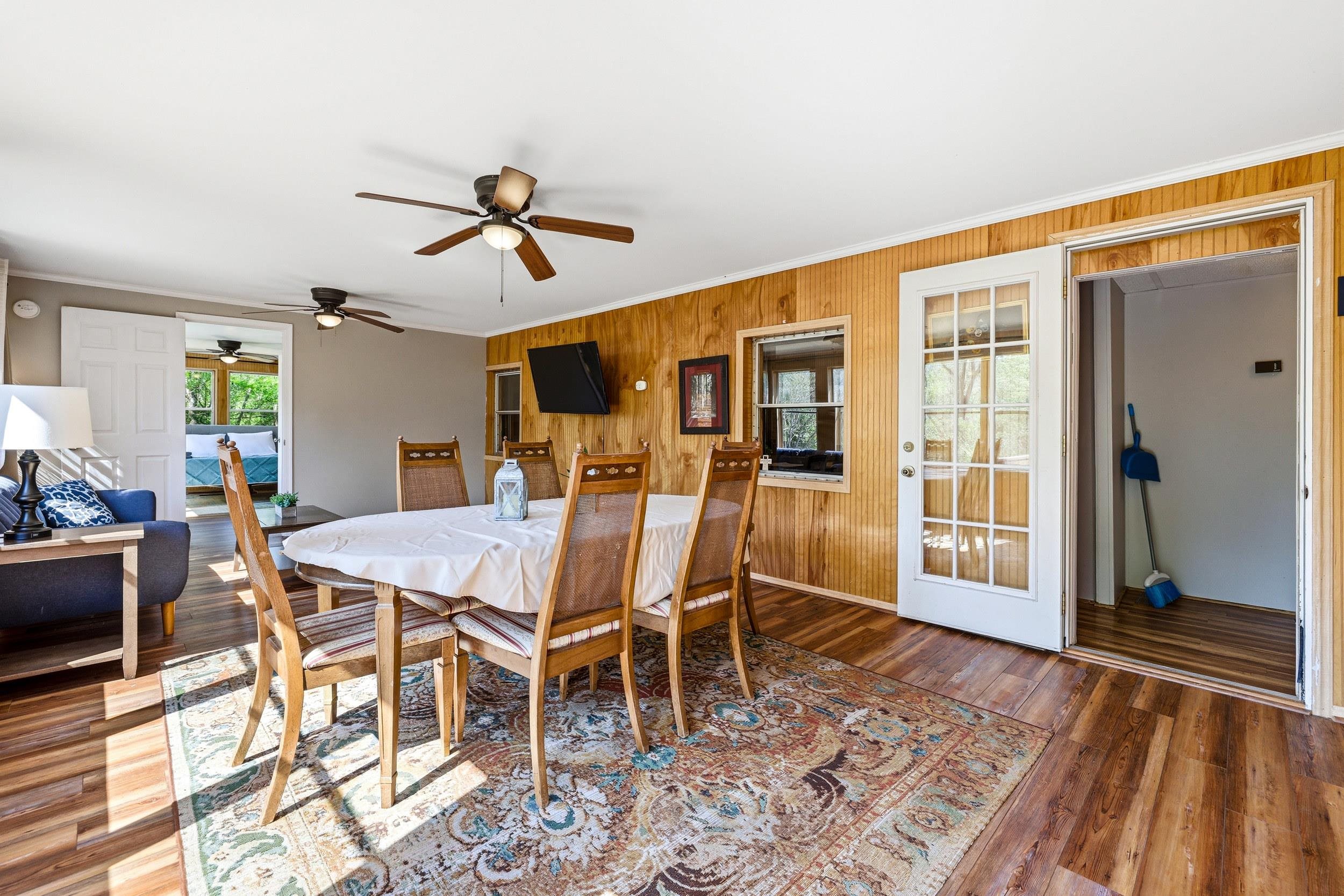 702 Richview Road Rileyville, VA 22650 - Photo 17 of 75 a dining room with wooden floor a chandelier fan a wooden table and chairs