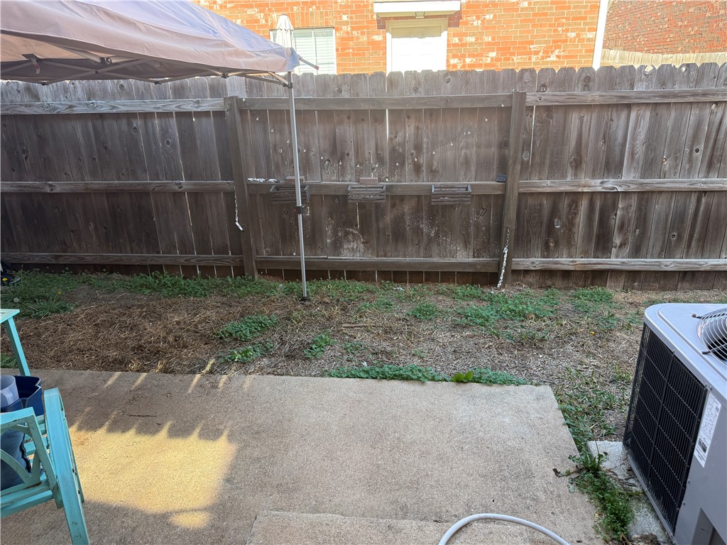 1001 Krenek Tap Road, Unit 2405 College Station, TX 77840 - Photo 19 of 24 a backyard with a wooden fence