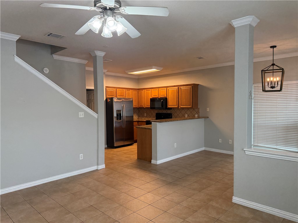 1001 Krenek Tap Road, Unit 2405 College Station, TX 77840 - Photo 5 of 24 a kitchen with stainless steel appliances kitchen island granite countertop a refrigerator and a sink