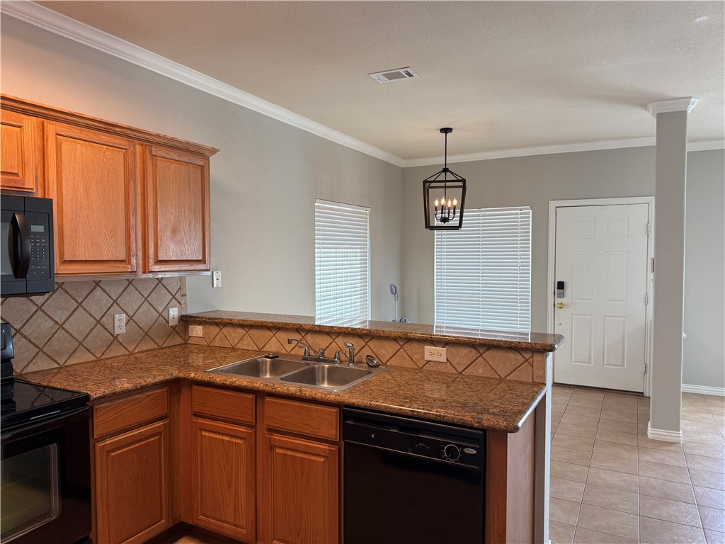 1001 Krenek Tap Road, Unit 2405 College Station, TX 77840 - Photo 6 of 24 a kitchen with granite countertop cabinets sink and window