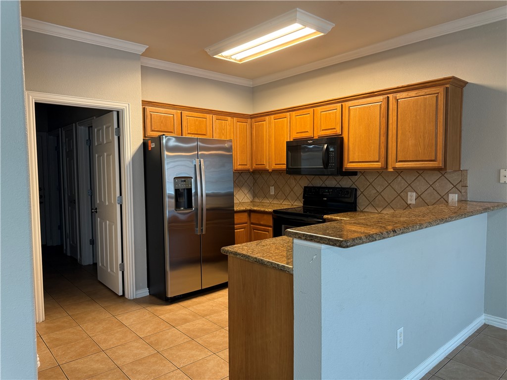 1001 Krenek Tap Road, Unit 2405 College Station, TX 77840 - Photo 8 of 24 a kitchen with stainless steel appliances granite countertop a refrigerator stove and sink