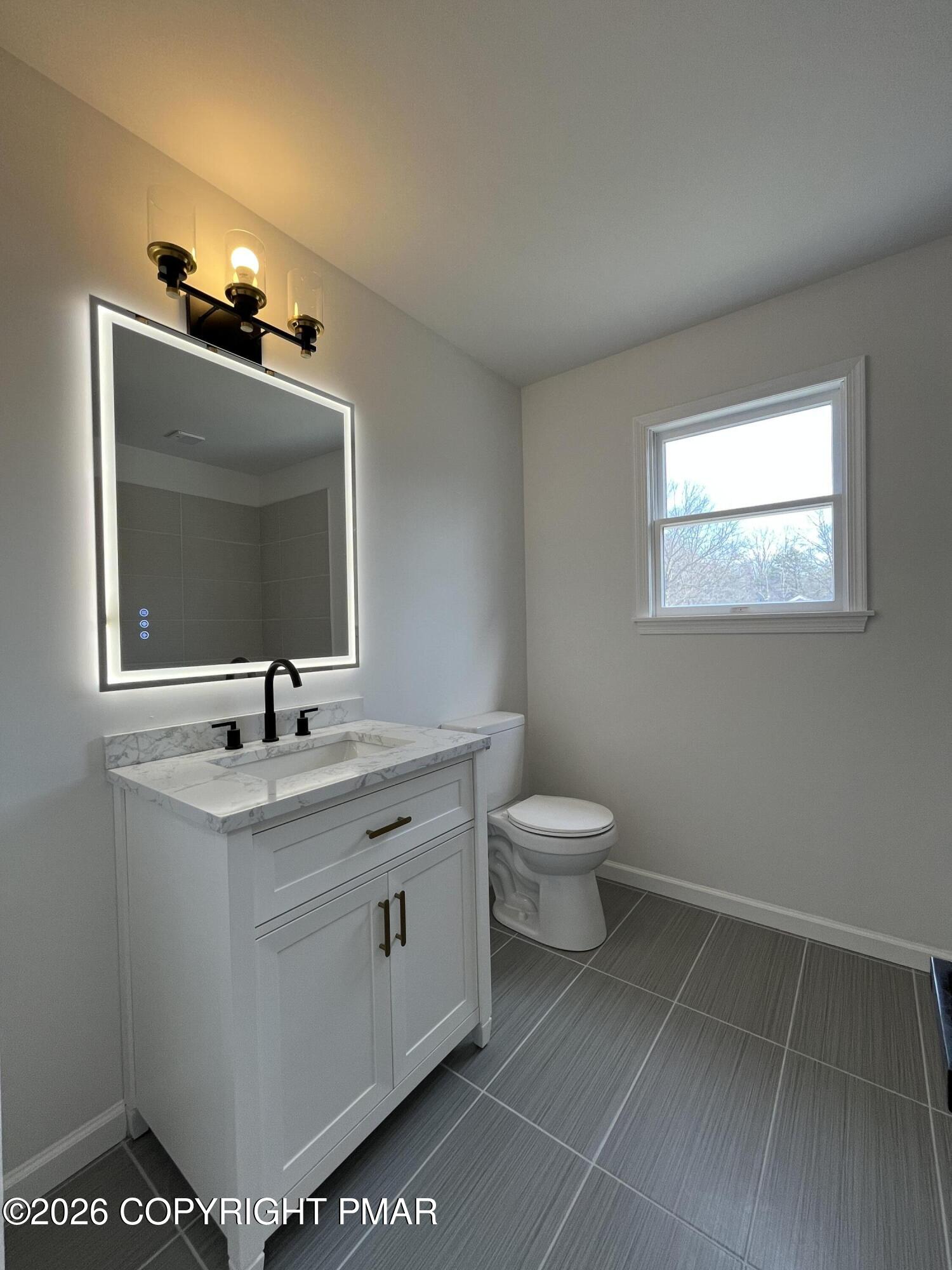 1281 Brian Lane Effort, PA 18330 - Photo 21 of 32 a bathroom with a toilet sink and mirror