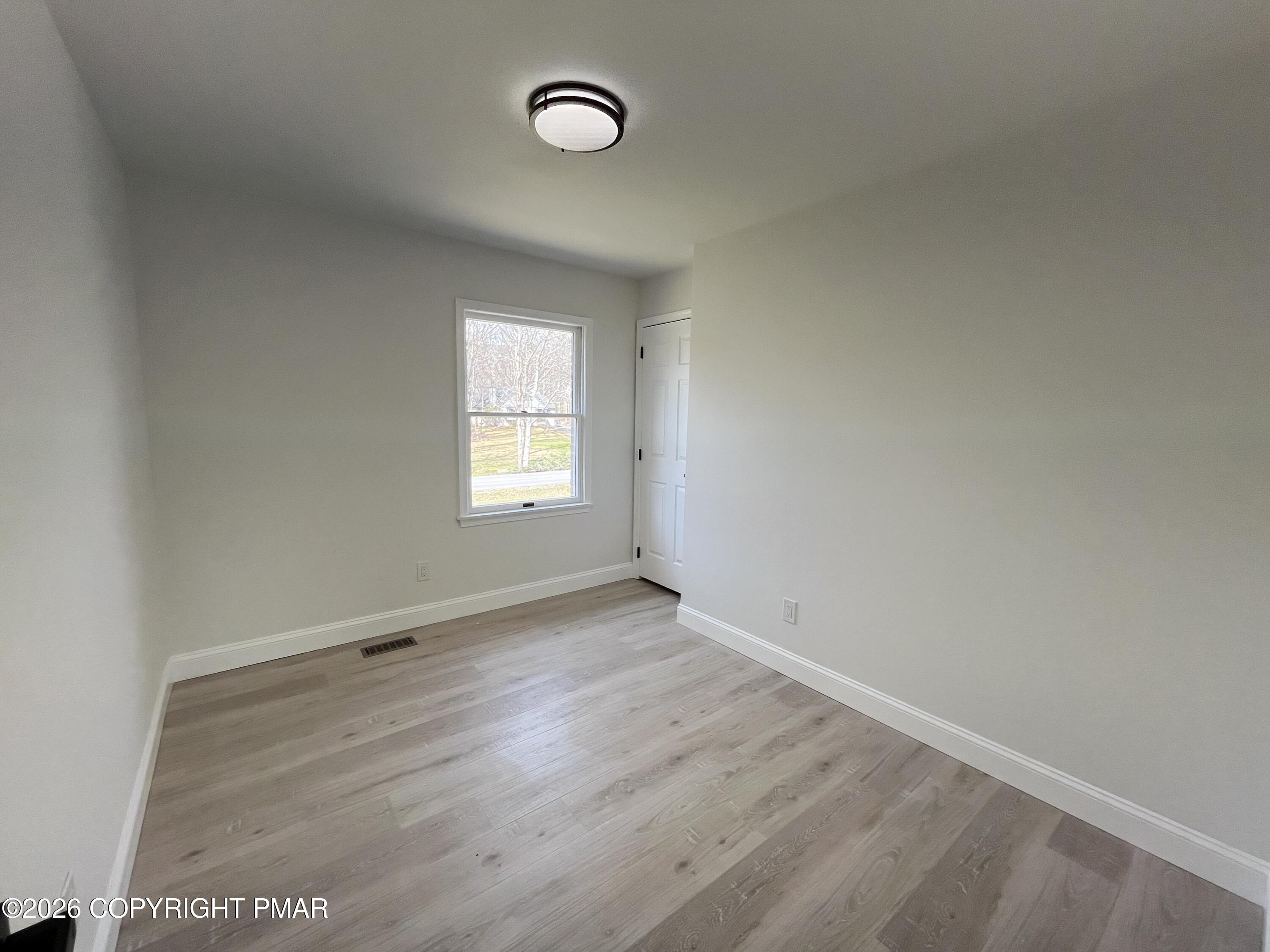 1281 Brian Lane Effort, PA 18330 - Photo 23 of 32 an empty room with wooden floor and windows