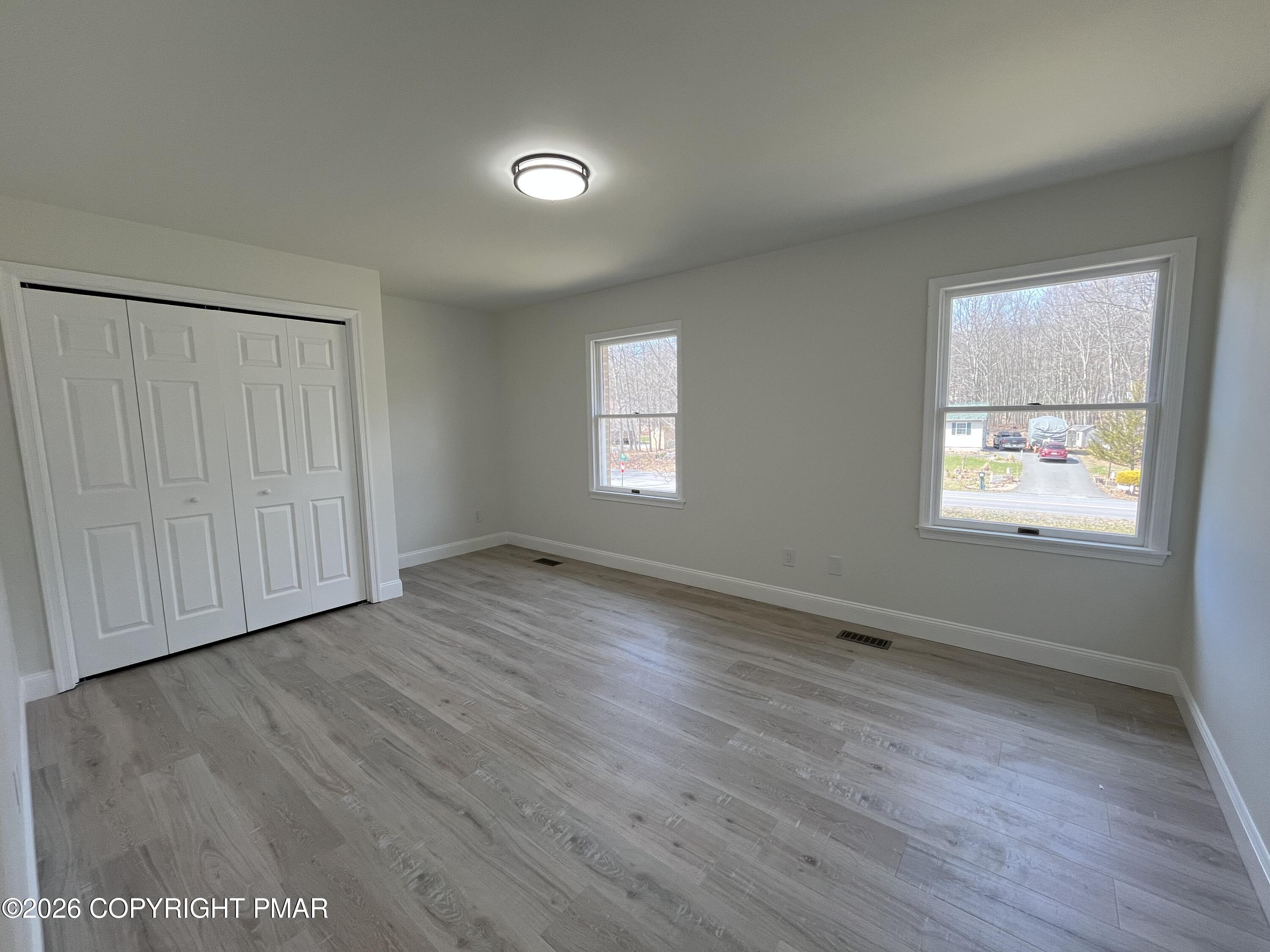 1281 Brian Lane Effort, PA 18330 - Photo 24 of 32 an empty room with wooden floor and windows