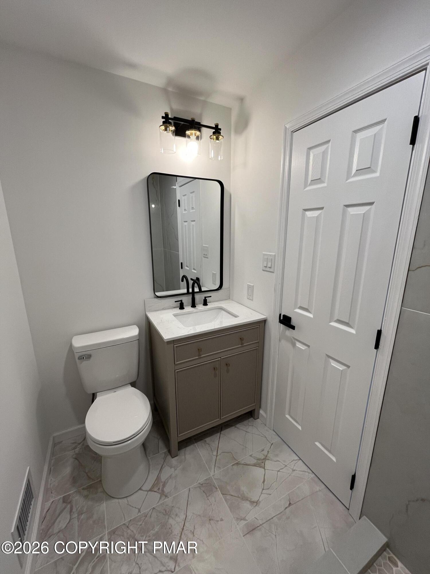 1281 Brian Lane Effort, PA 18330 - Photo 30 of 32 a bathroom with a toilet a sink and mirror