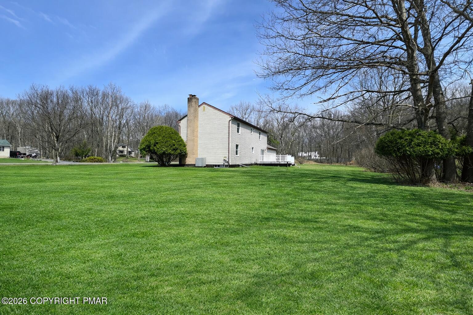 1281 Brian Lane Effort, PA 18330 - Photo 32 of 32 a backyard of a house with plants and large trees