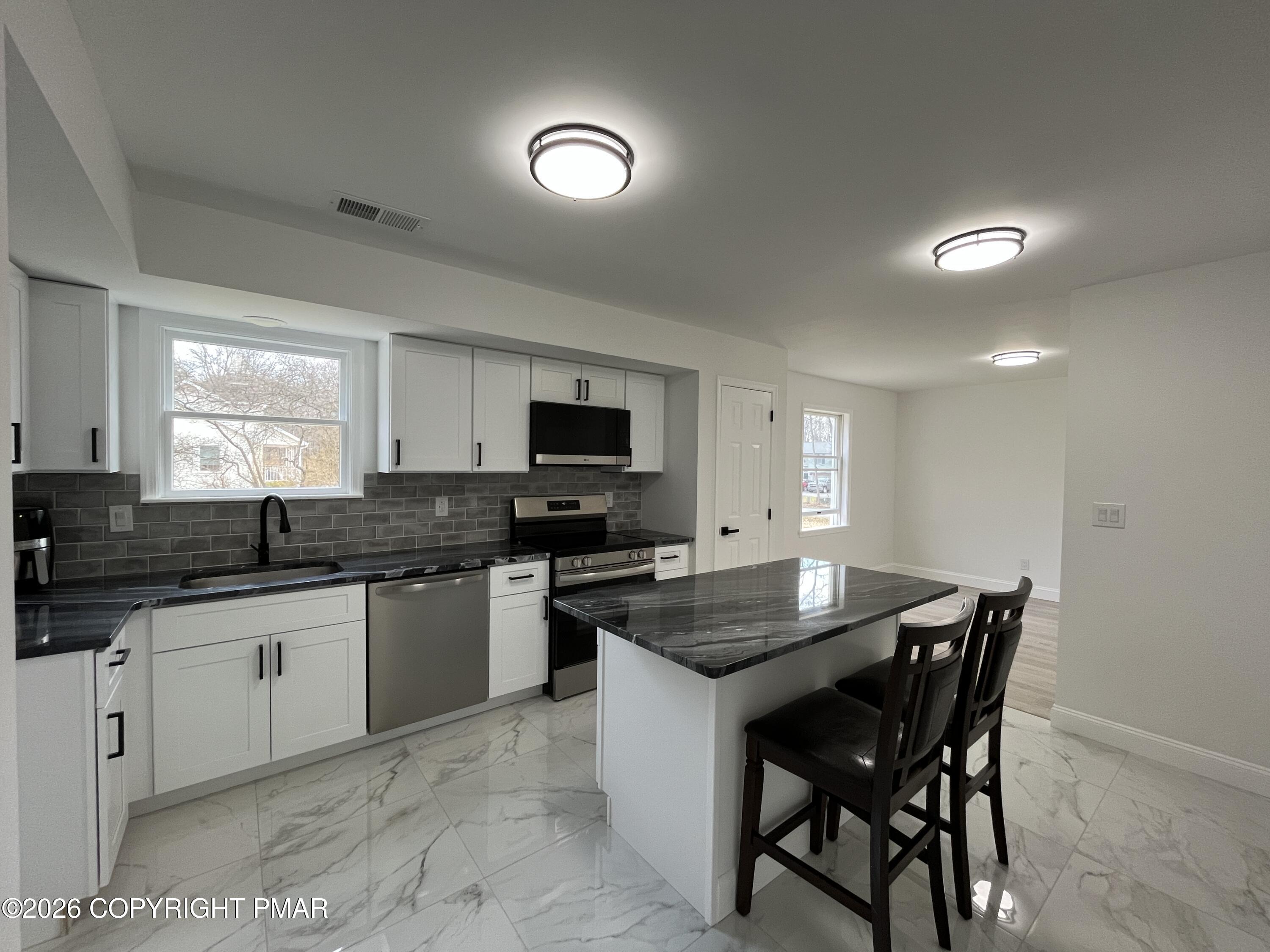1281 Brian Lane Effort, PA 18330 - Photo 8 of 32 a kitchen with granite countertop a sink and white appliances