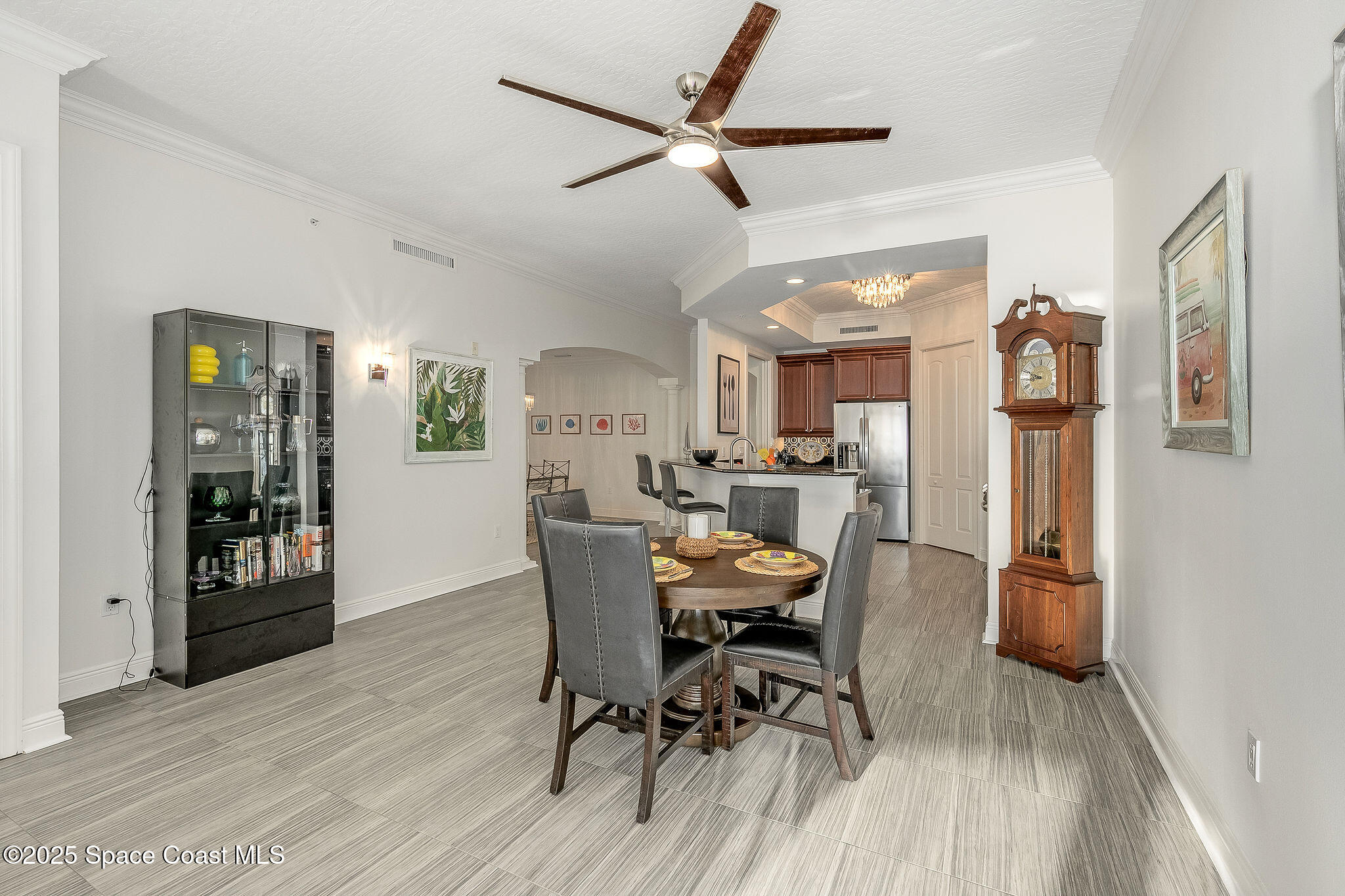 2012 Julep Drive, Unit 304 Cocoa Beach, FL 32931 - Photo 11 of 67 a view of a dining room with furniture and a chandelier