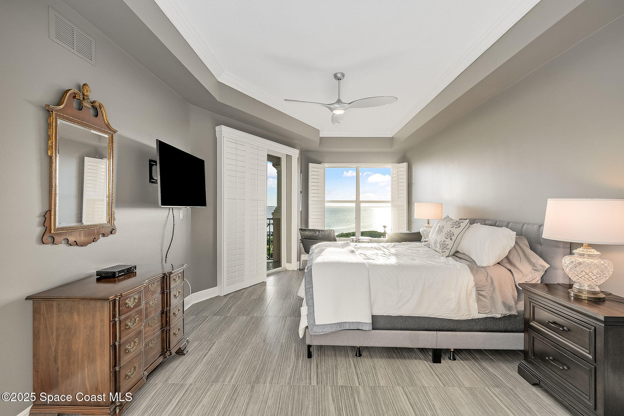 2012 Julep Drive, Unit 304 Cocoa Beach, FL 32931 - Photo 22 of 67 a bedroom with a bed wooden floor and flat screen tv