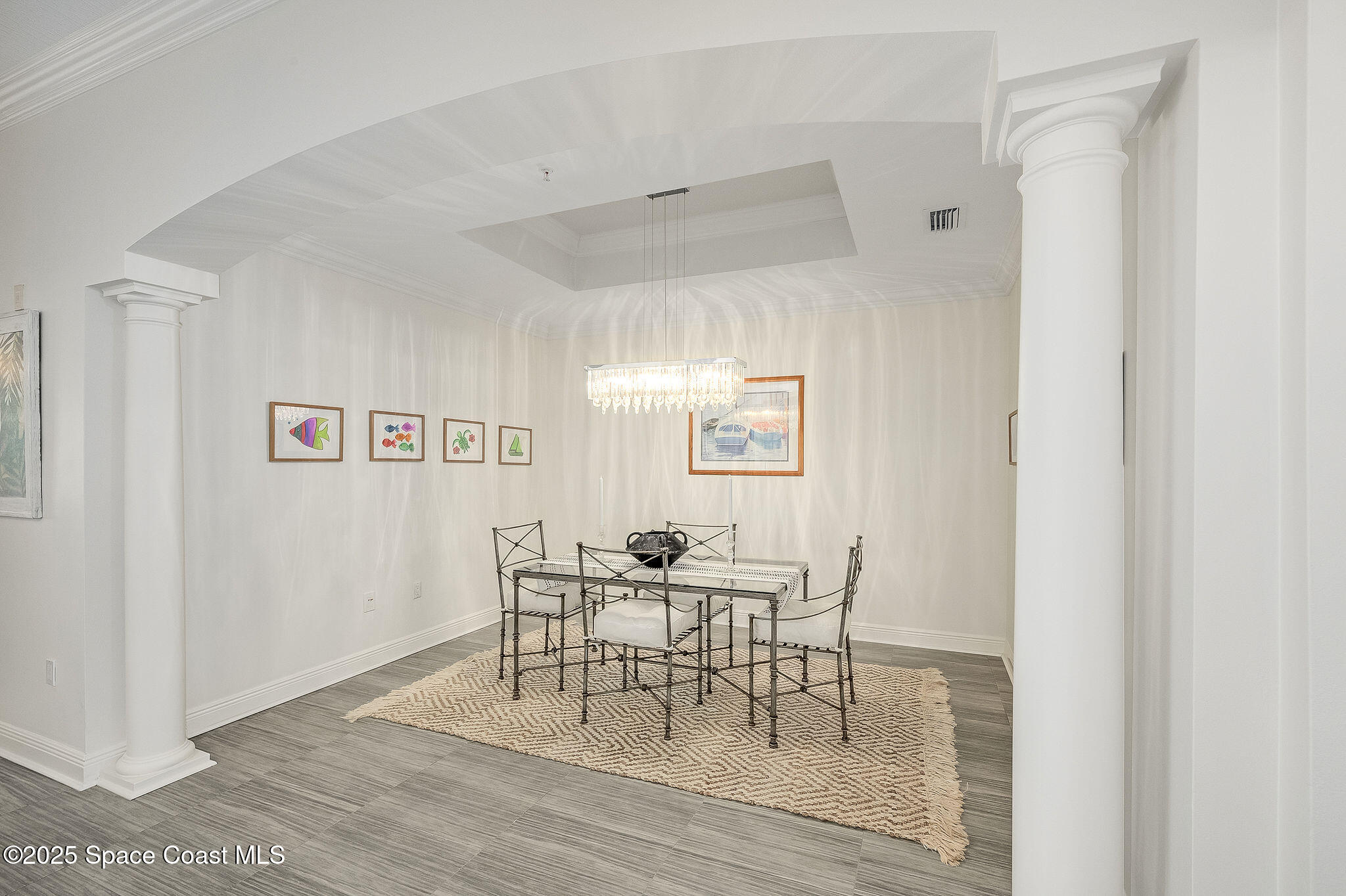 2012 Julep Drive, Unit 304 Cocoa Beach, FL 32931 - Photo 29 of 67 a dining room with wooden floor and a hallway