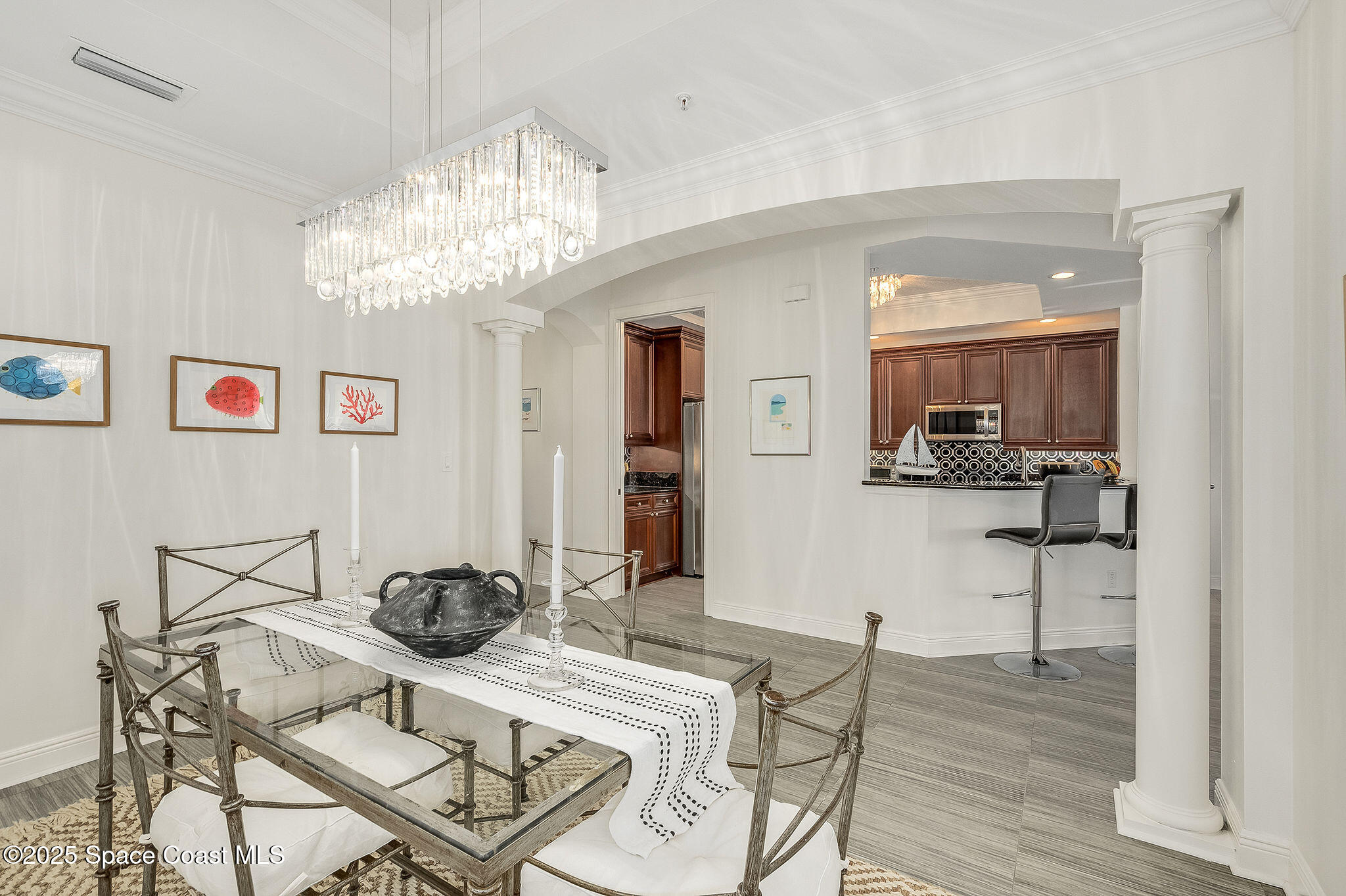2012 Julep Drive, Unit 304 Cocoa Beach, FL 32931 - Photo 31 of 67 a view of a dining room with furniture and chandelier