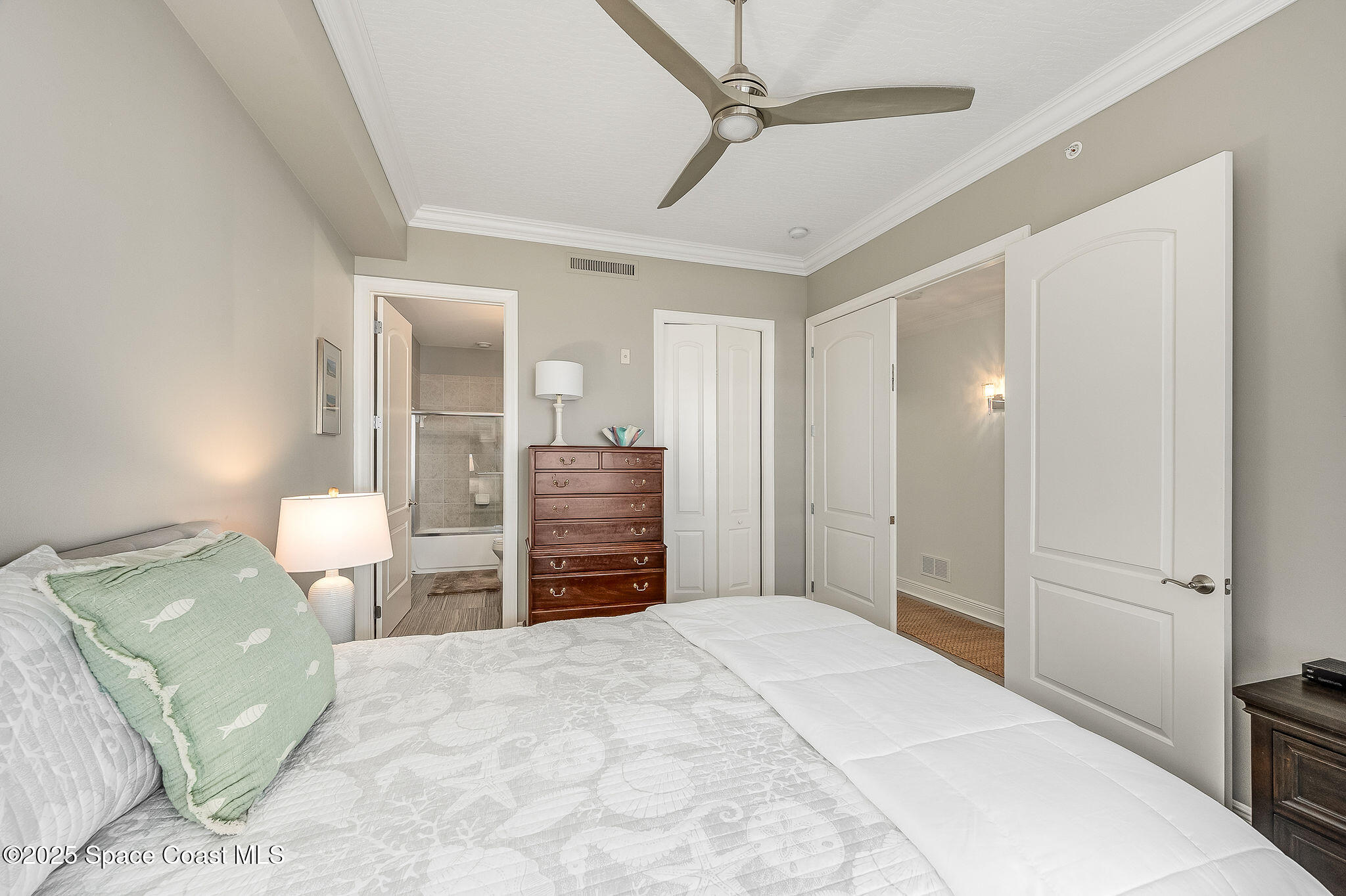 2012 Julep Drive, Unit 304 Cocoa Beach, FL 32931 - Photo 34 of 67 a bedroom with a bed and dresser with mirror