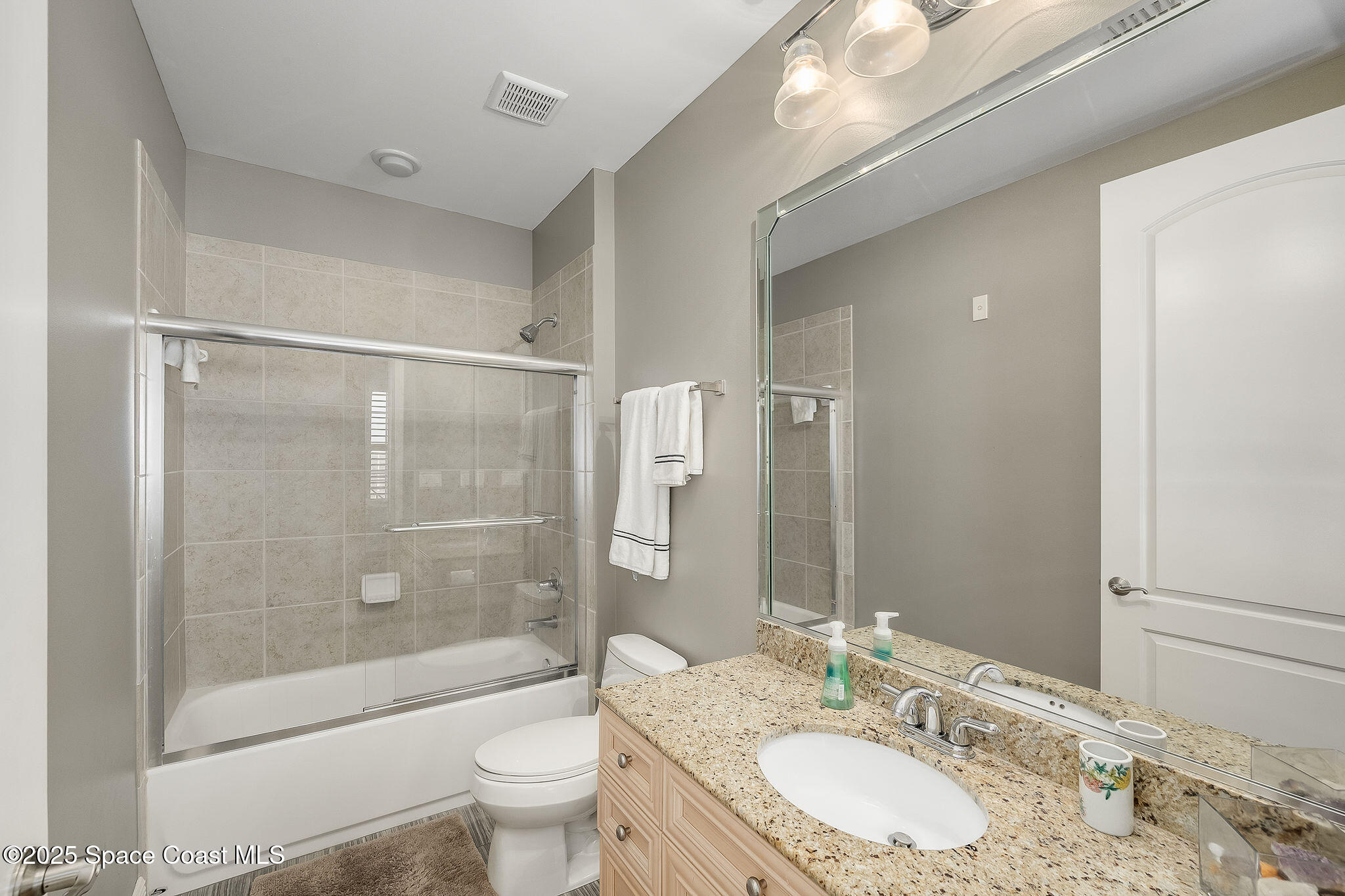 2012 Julep Drive, Unit 304 Cocoa Beach, FL 32931 - Photo 35 of 67 a bathroom with a granite countertop sink toilet and shower