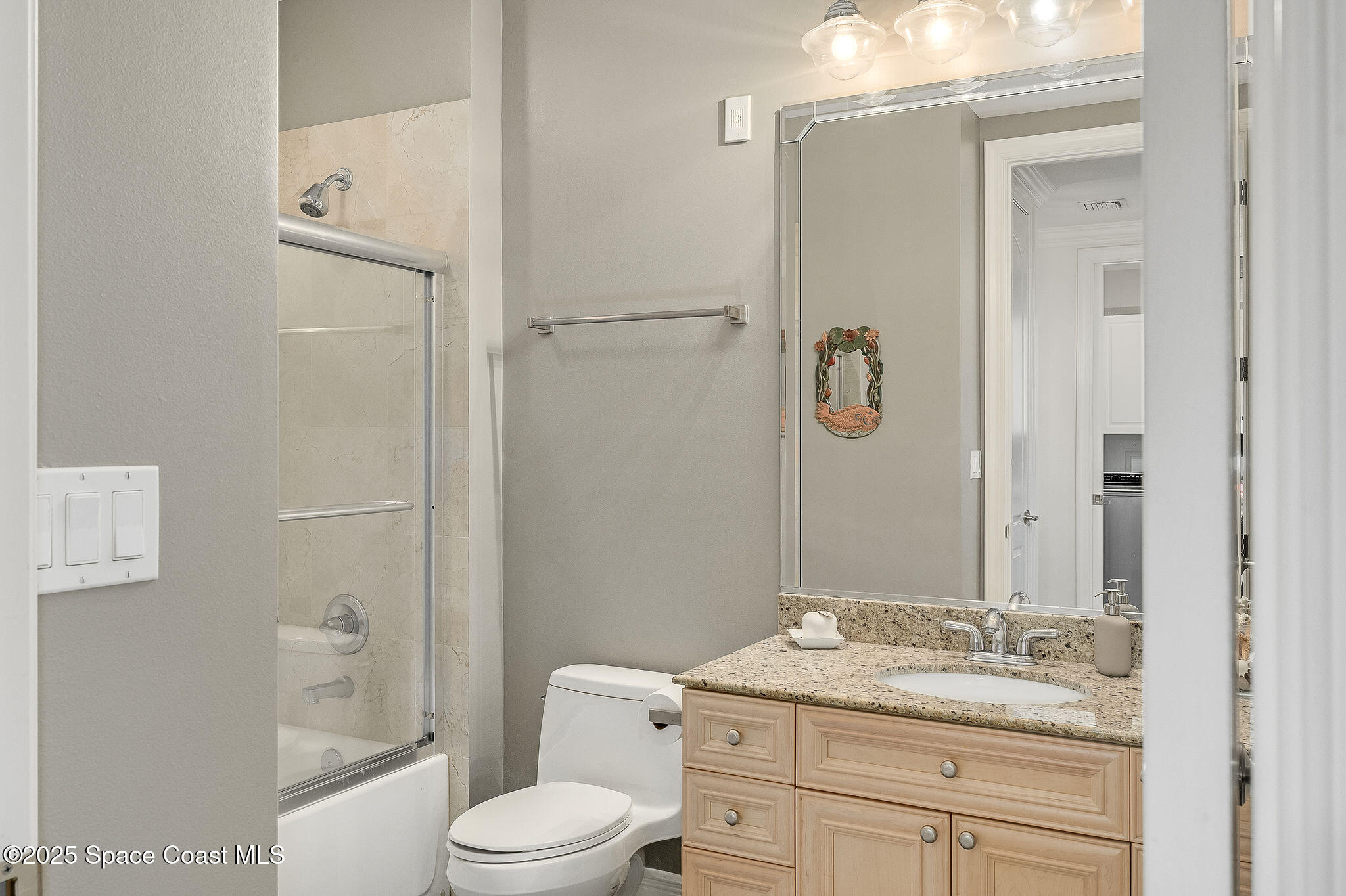 2012 Julep Drive, Unit 304 Cocoa Beach, FL 32931 - Photo 38 of 67 a bathroom with a granite countertop sink toilet a mirror a vanity and shower