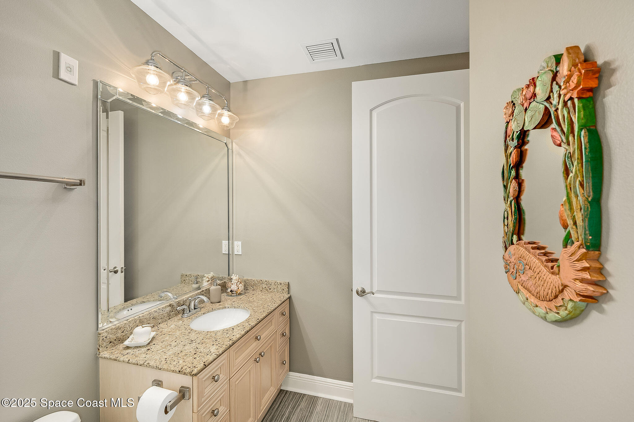 2012 Julep Drive, Unit 304 Cocoa Beach, FL 32931 - Photo 40 of 67 a bathroom with a granite countertop sink and a mirror