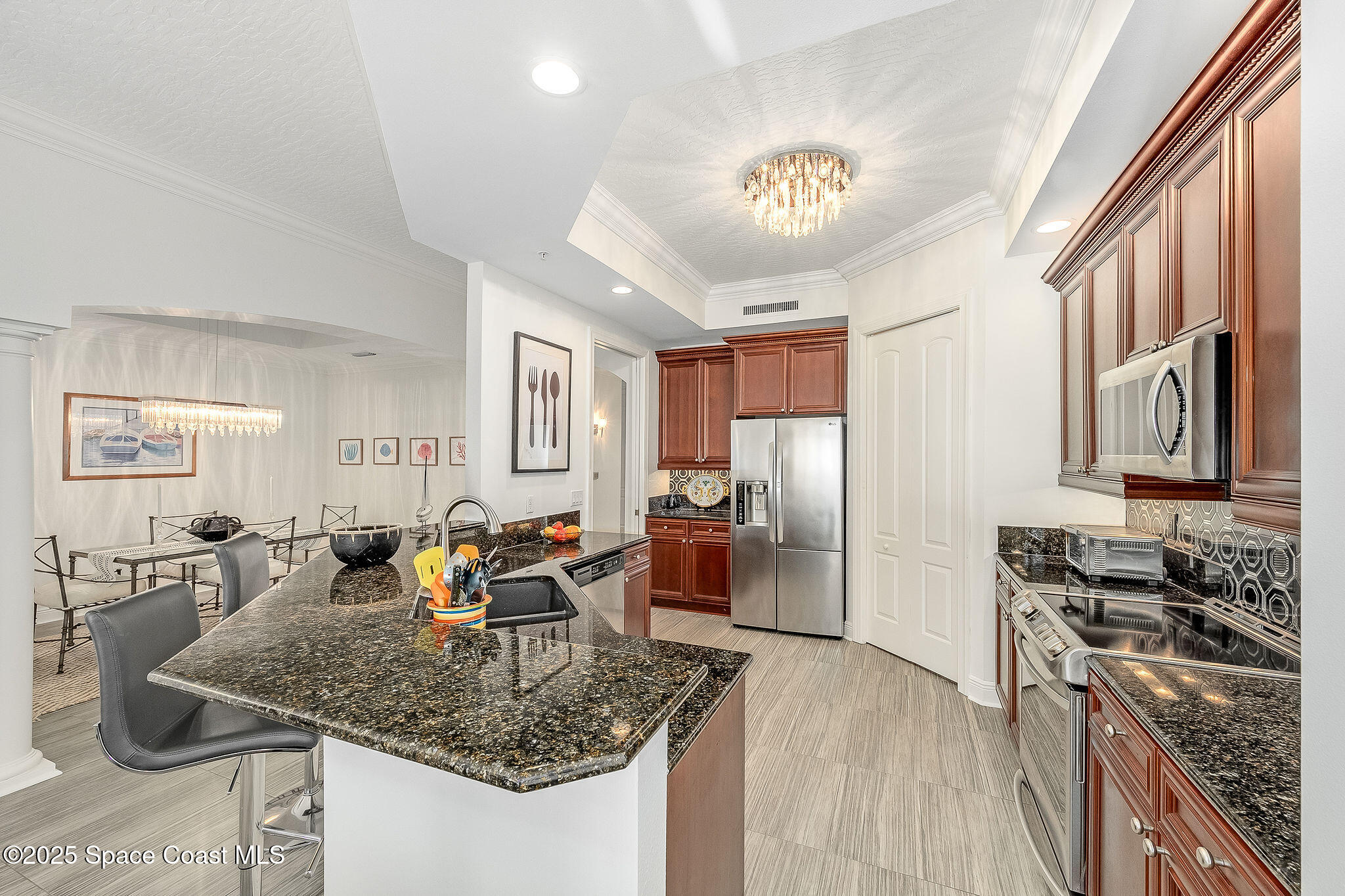 2012 Julep Drive, Unit 304 Cocoa Beach, FL 32931 - Photo 5 of 67 a kitchen with stainless steel appliances granite countertop a sink stove and refrigerator