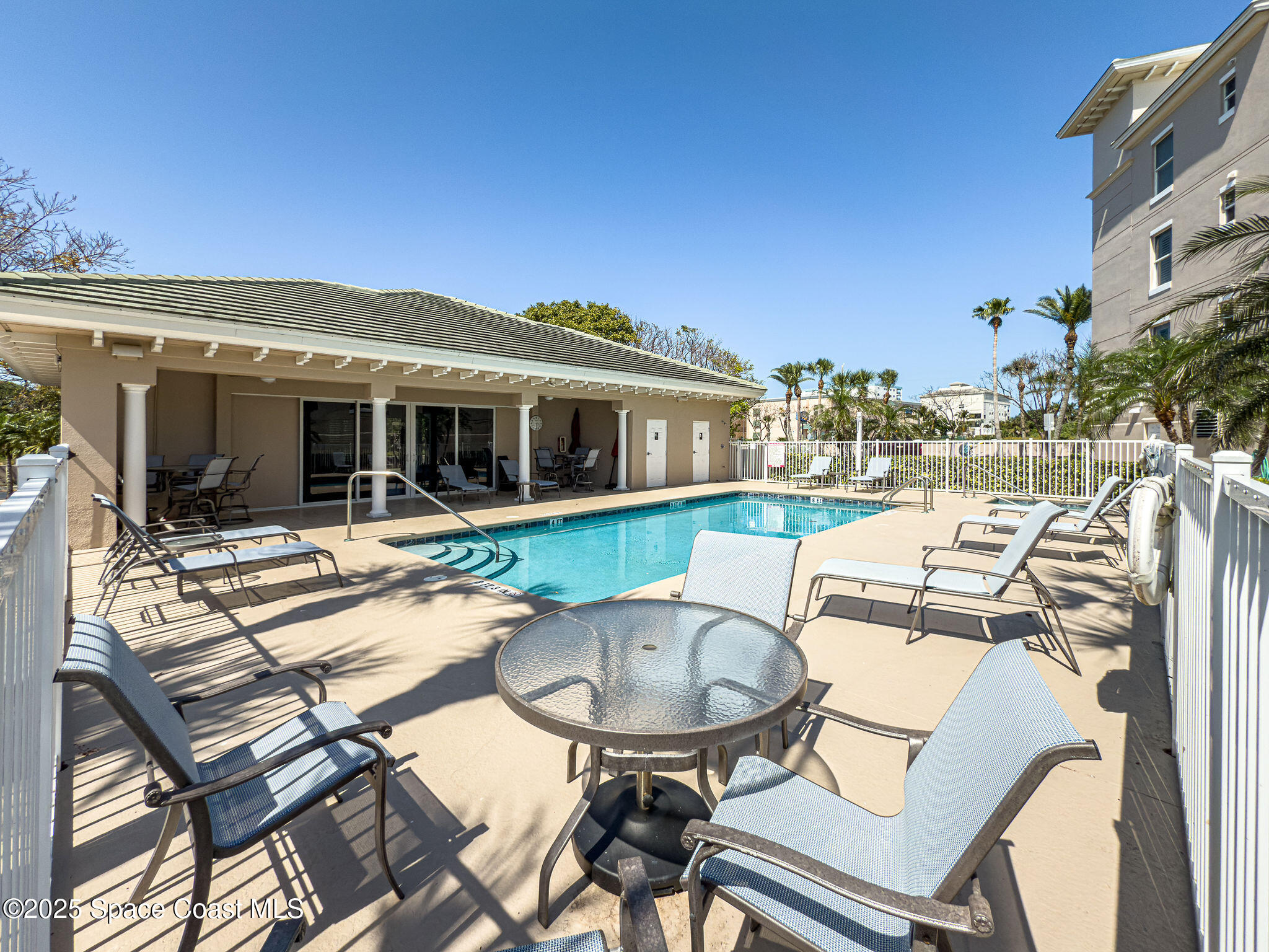 2012 Julep Drive, Unit 304 Cocoa Beach, FL 32931 - Photo 56 of 67 a view of a patio with table and chairs