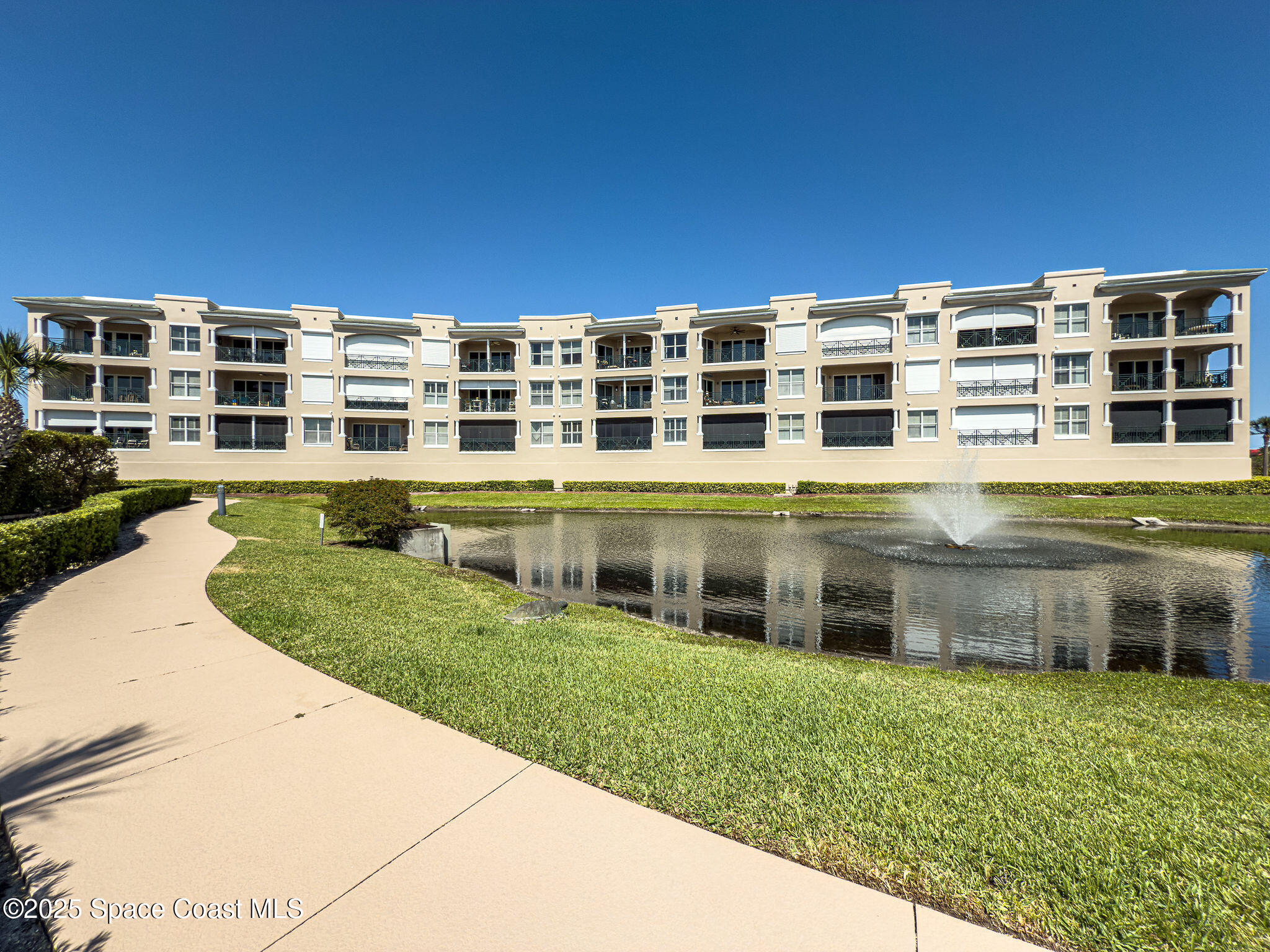 2012 Julep Drive, Unit 304 Cocoa Beach, FL 32931 - Photo 59 of 67 a front view of a building with a yard