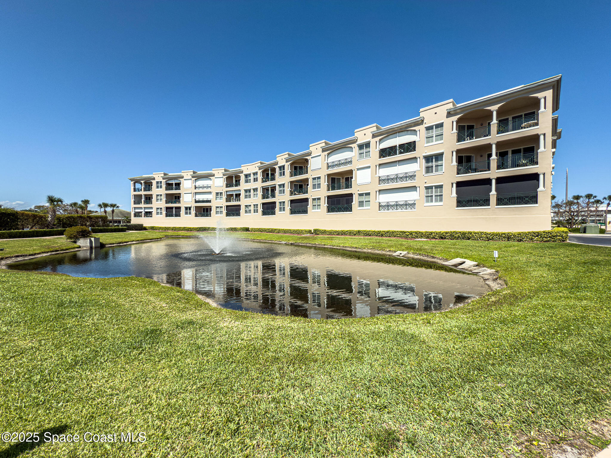 2012 Julep Drive, Unit 304 Cocoa Beach, FL 32931 - Photo 60 of 67 a view of a large building with a yard