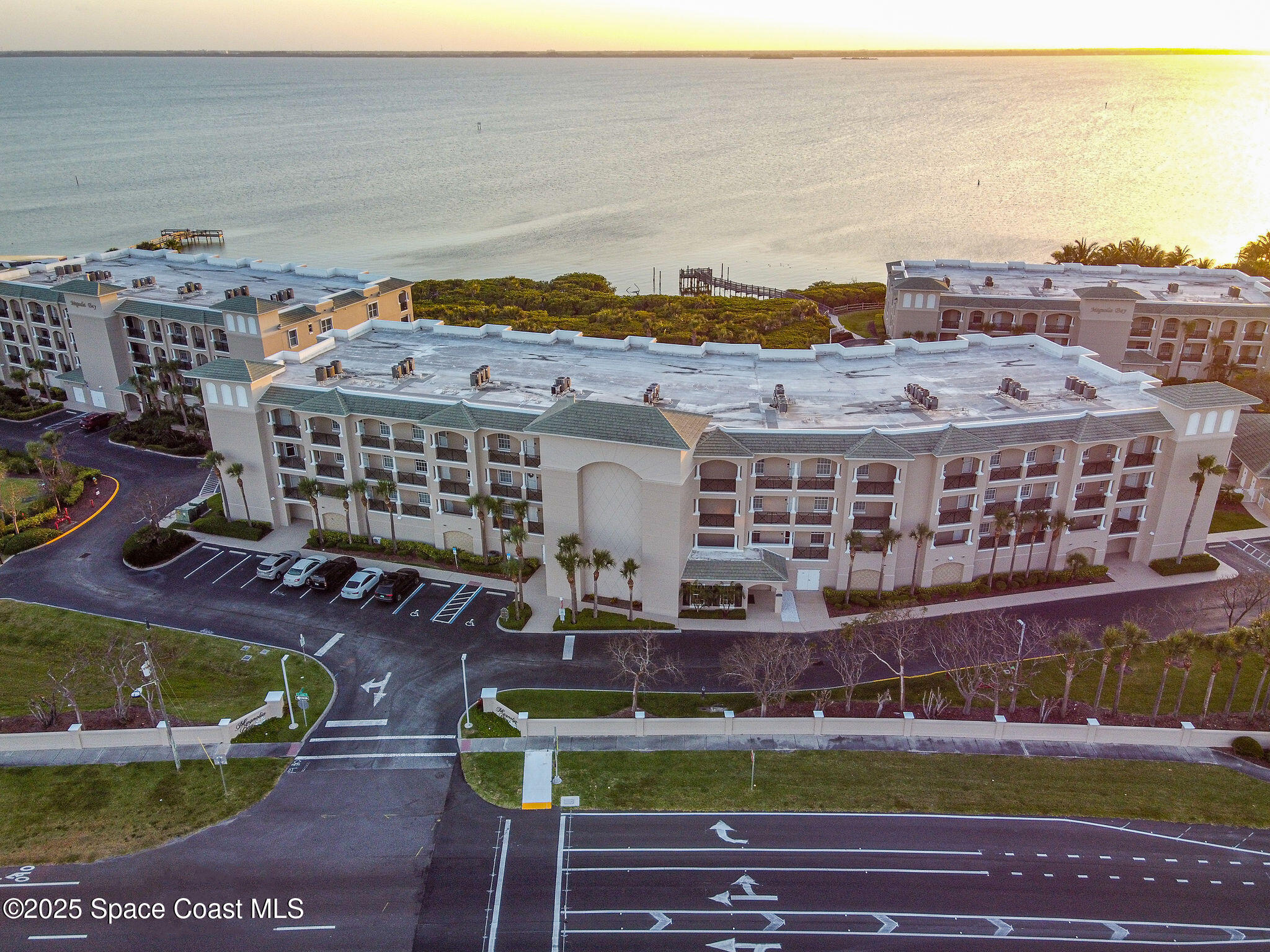 2012 Julep Drive, Unit 304 Cocoa Beach, FL 32931 - Photo 63 of 67 a front view of a building with glass windows and a table