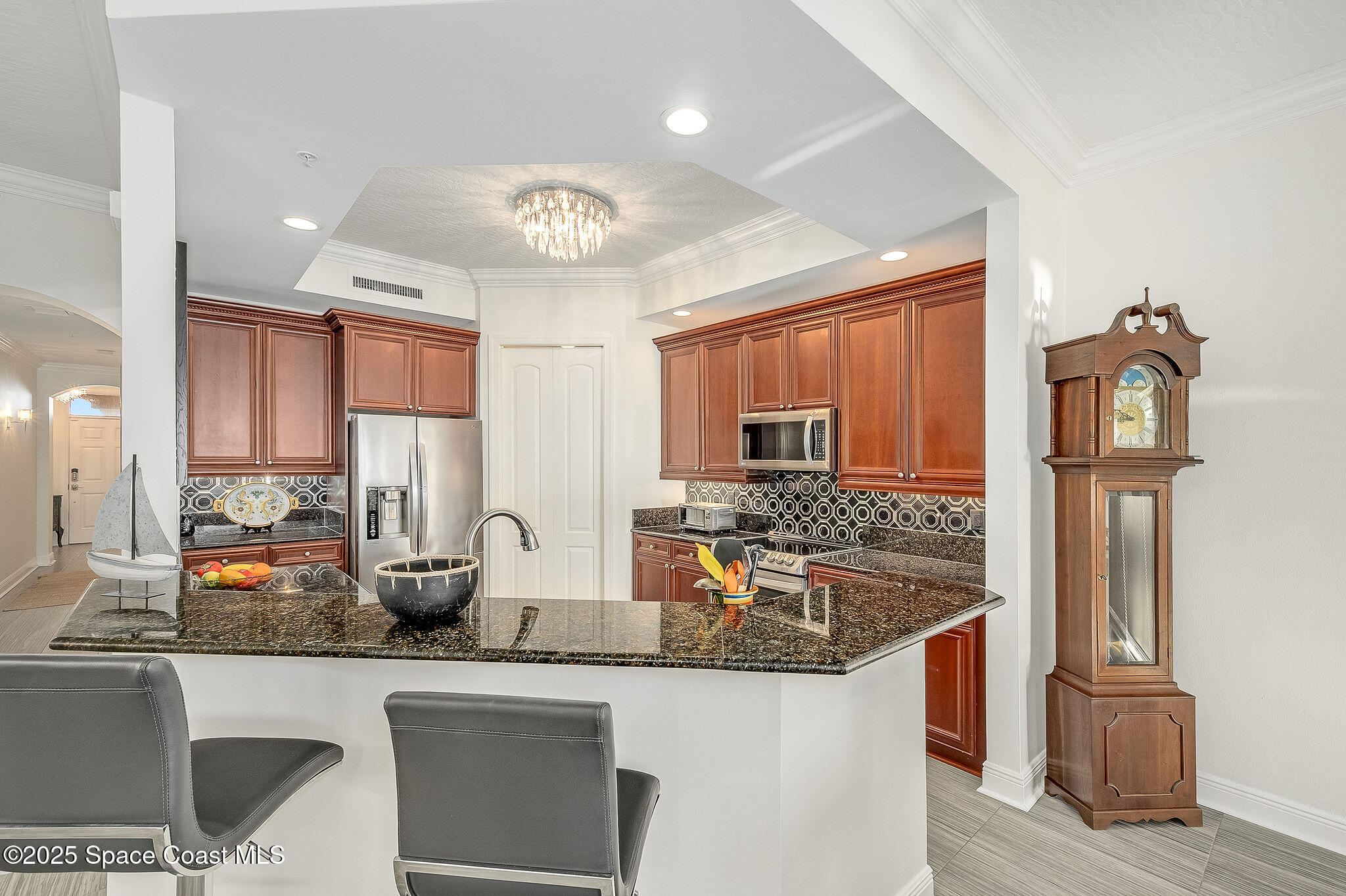 2012 Julep Drive, Unit 304 Cocoa Beach, FL 32931 - Photo 8 of 67 a kitchen with stainless steel appliances granite countertop a sink stove and refrigerator