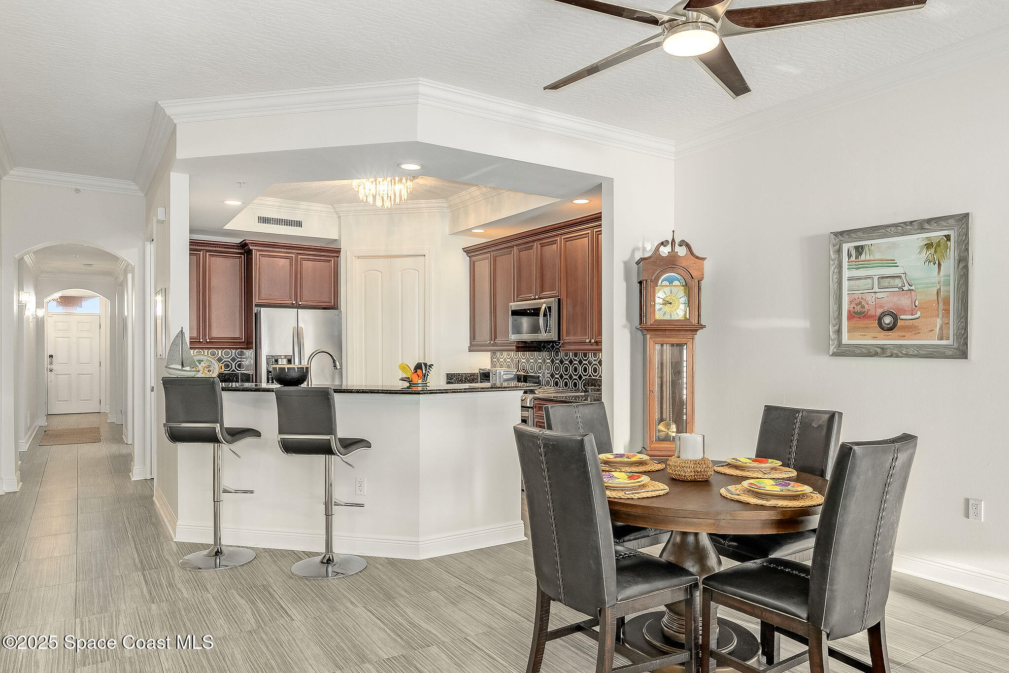 2012 Julep Drive, Unit 304 Cocoa Beach, FL 32931 - Photo 10 of 67 a view of a dining room with furniture and a chandelier fan