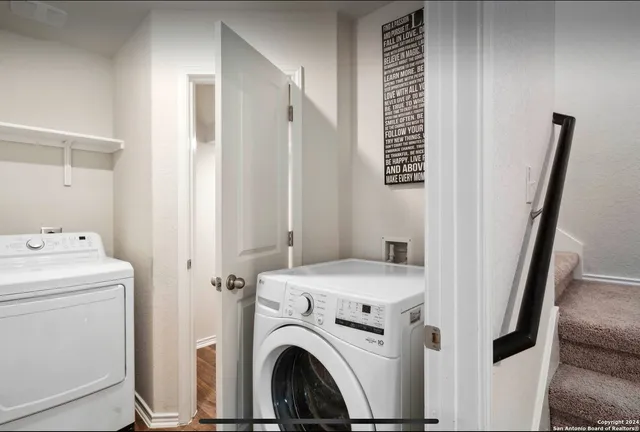 a view of storage and utility room with washer and dryer