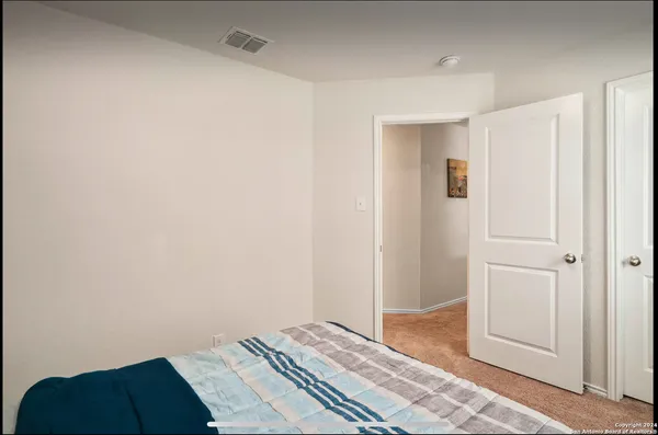 a bedroom with a bed and a hallway