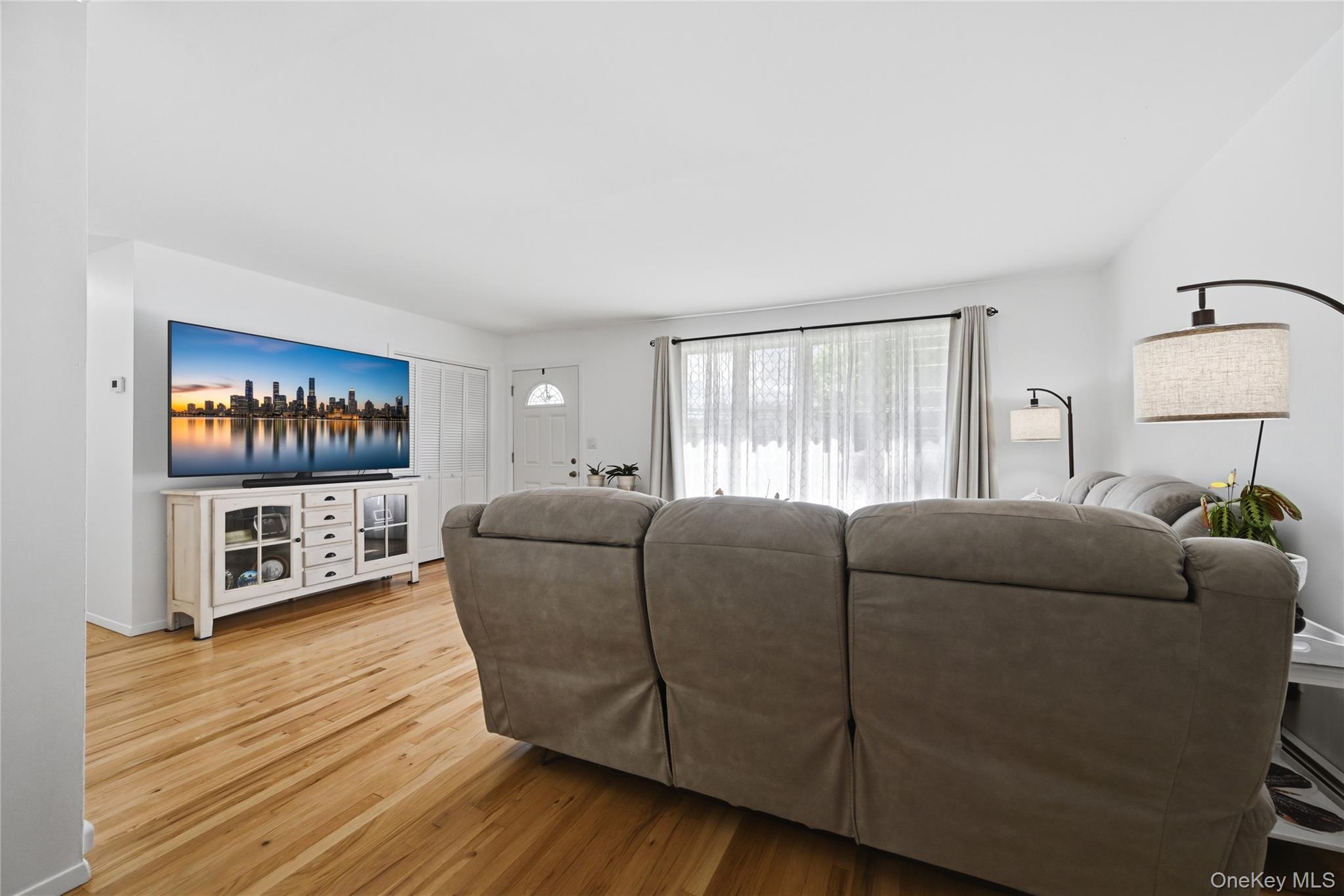 35 Randall Road Shoreham, NY 11786 - Photo 12 of 32 a living room with furniture and a flat screen tv