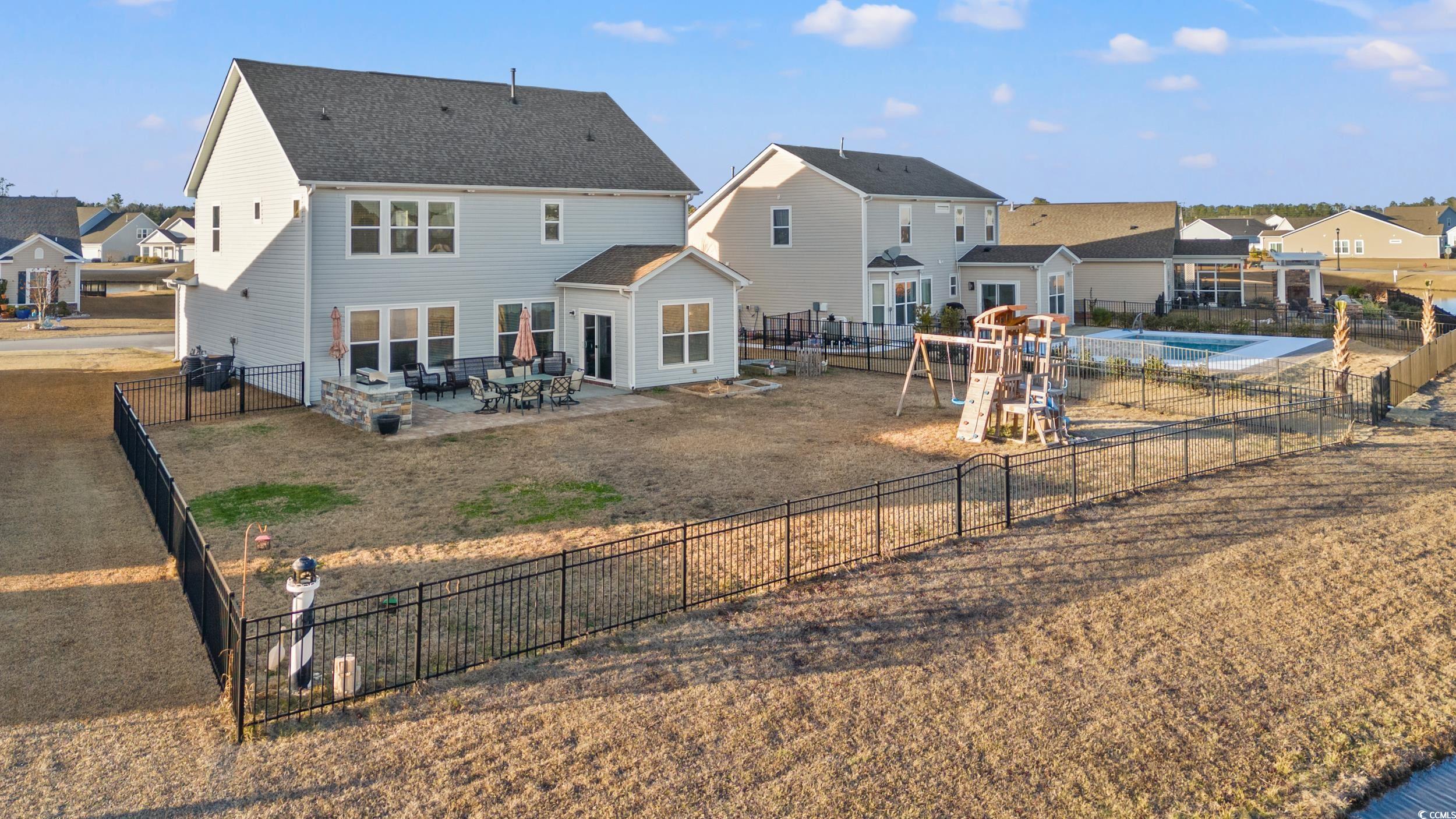 556 Majorca Loop Myrtle Beach, SC 29579 - Photo 26 of 31 Back of property featuring a patio and a playgroun