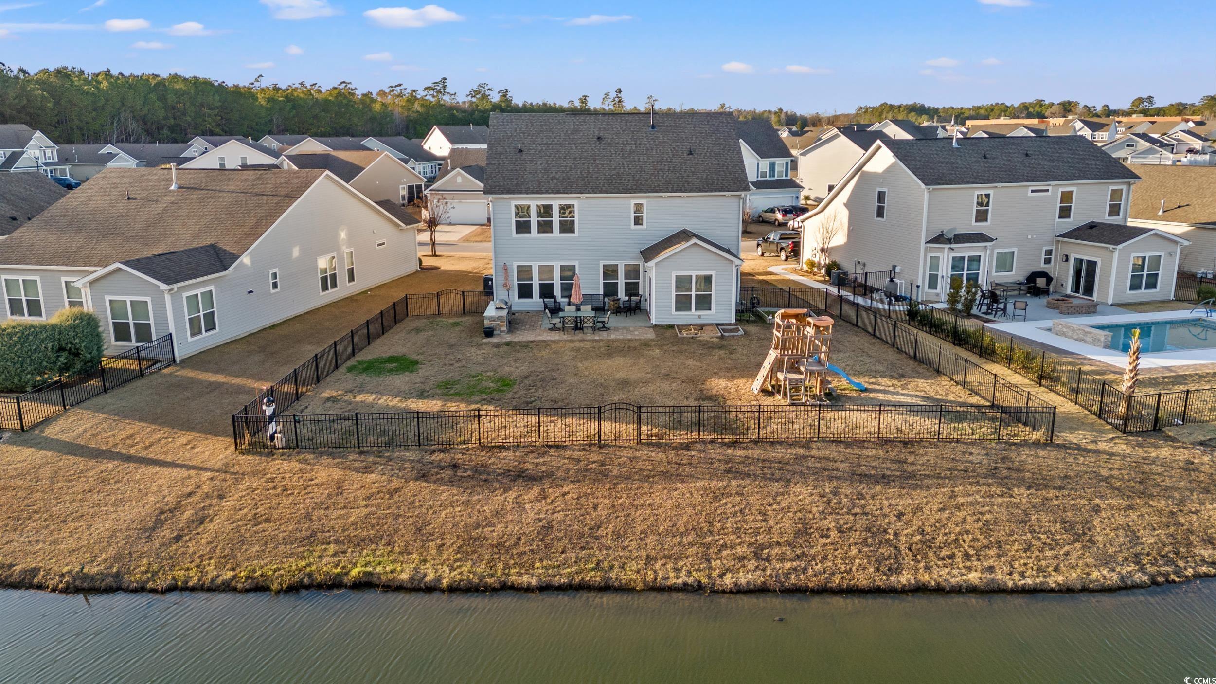 556 Majorca Loop Myrtle Beach, SC 29579 - Photo 27 of 31 Rear view of house featuring a water view, a playg