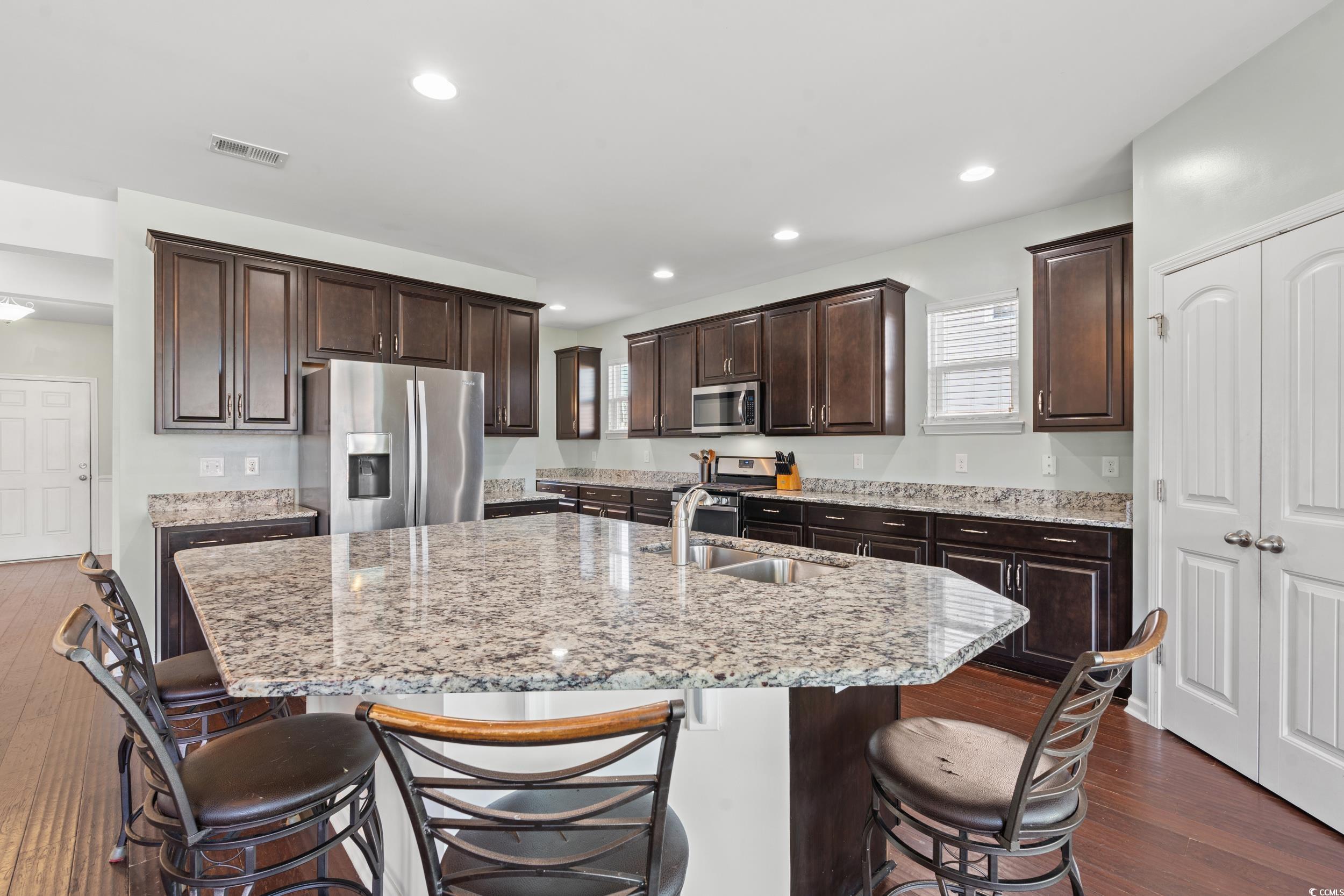 556 Majorca Loop Myrtle Beach, SC 29579 - Photo 5 of 31 Kitchen featuring sink, dark wood-type flooring, a