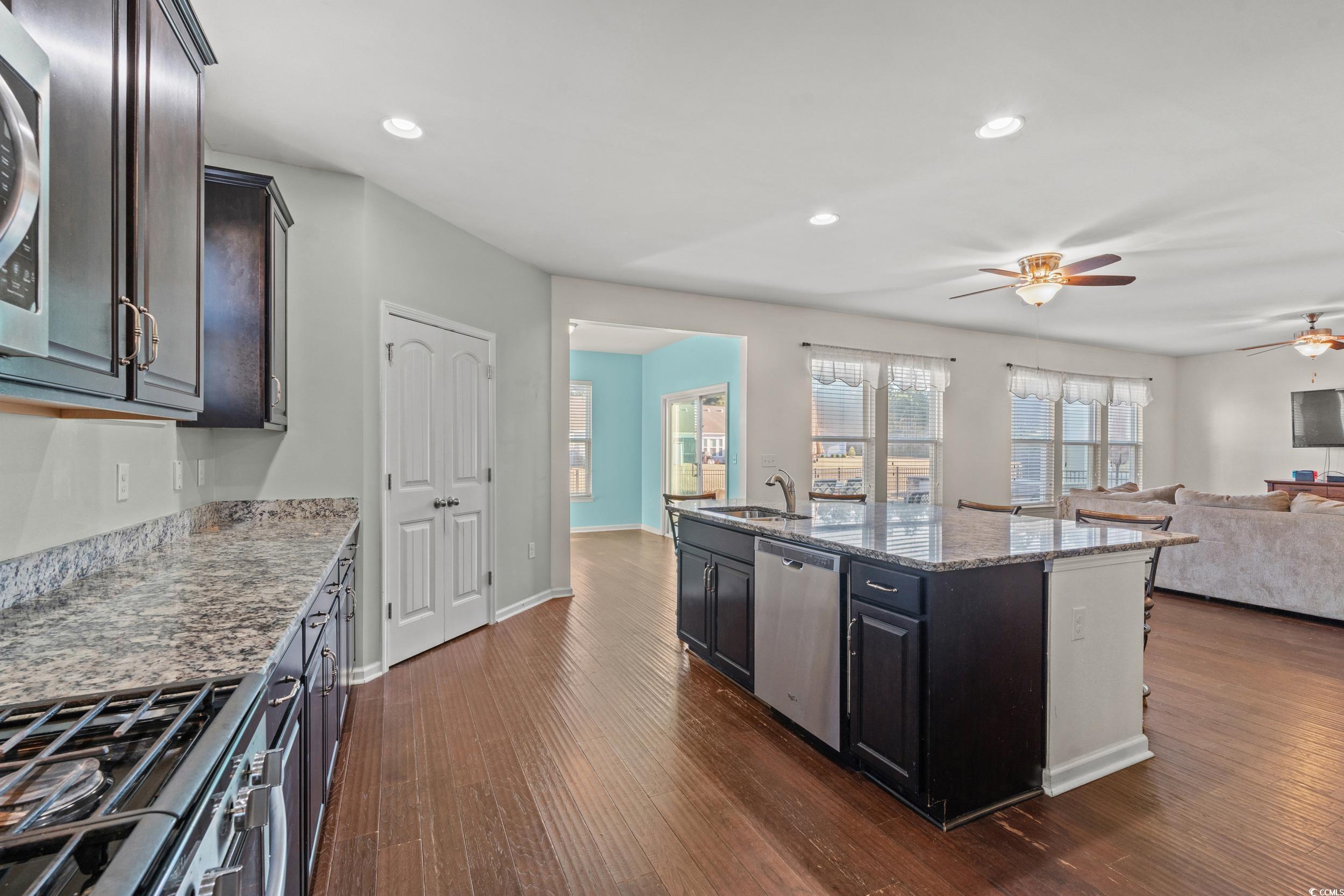 556 Majorca Loop Myrtle Beach, SC 29579 - Photo 7 of 31 Kitchen featuring sink, a kitchen island with sink