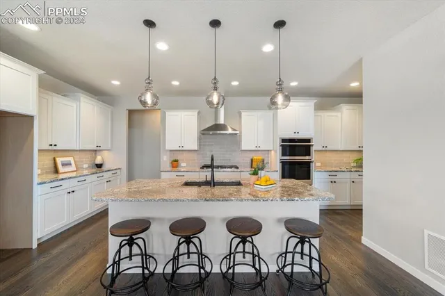 a large kitchen with a table and chairs