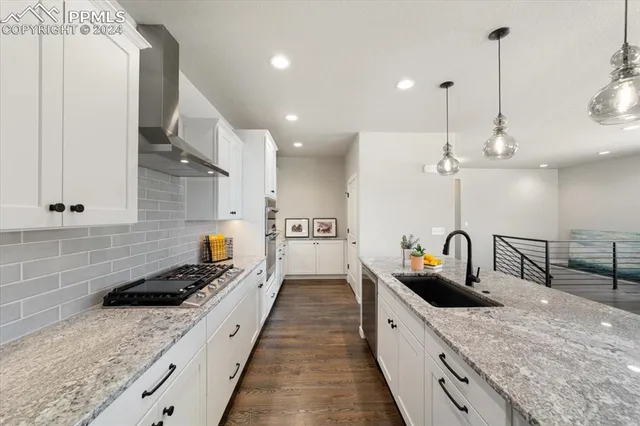 a large kitchen with kitchen island a sink a counter space and stainless steel appliances