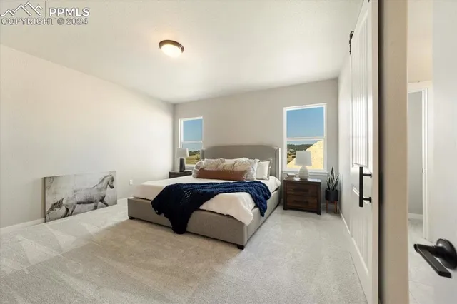 a spacious bedroom with a bed and window