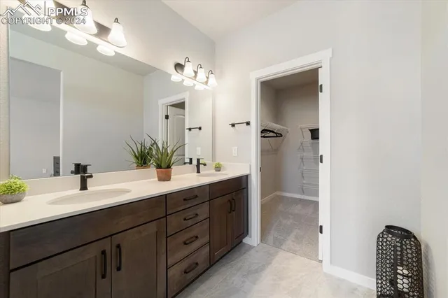 a spacious bathroom with a double vanity sink shower and a mirror