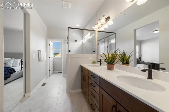 a bathroom with a sink double vanity and a shower