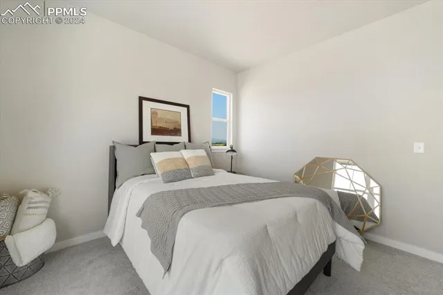 a bedroom with a bed and a painting