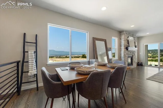 a dining room with furniture window and wooden floor