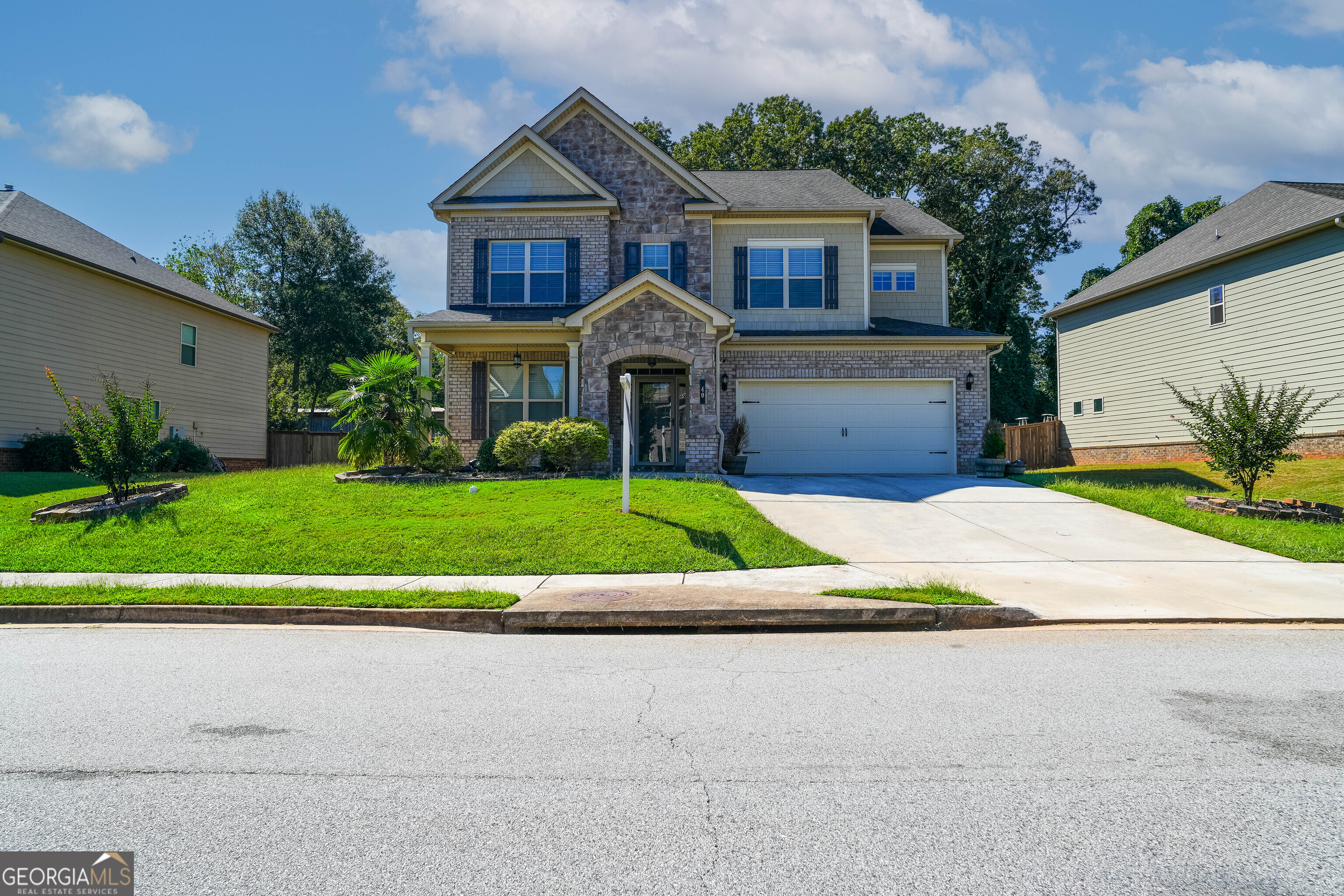 40 Brickstone Parkway Covington, GA 30016 - Photo 1 of 1 a front view of a house with a yard and garage