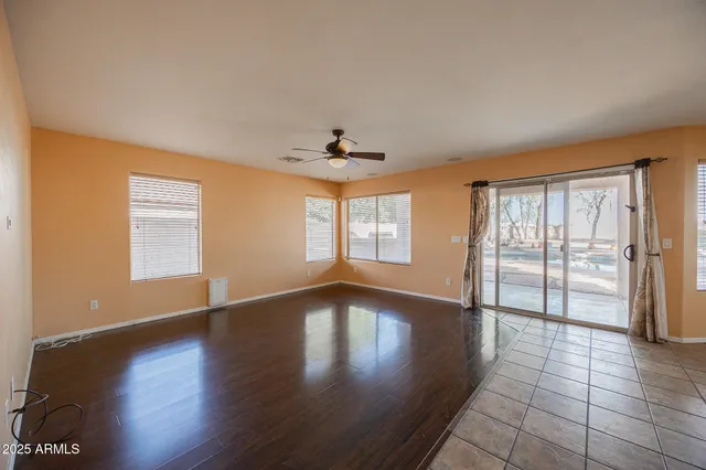 a view of a livingroom with a ceiling fan and window