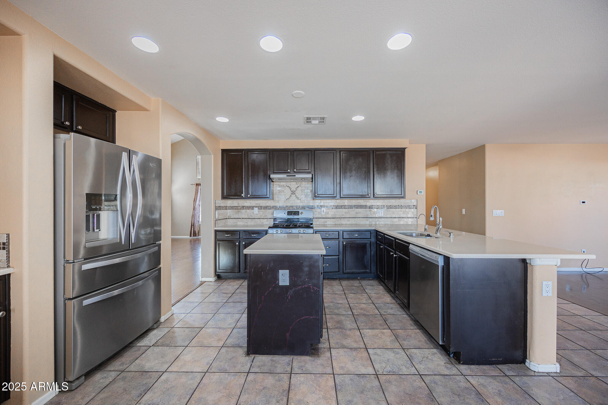 2300 East Augusta Avenue Chandler, AZ 85249 - Photo 16 of 53 a kitchen with stainless steel appliances granite countertop a stove a sink and a refrigerator